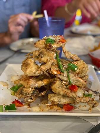 Crawfish & Noodles signature dishes Viet-Cajun Crawfish, Salt and Pepper Blue Crabs, Vietnamese Fried Chicken Wings, Bo Luc Lac (Shaking Beef)